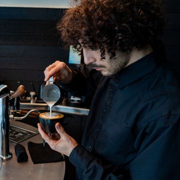 Un barista a una cafeteria de Hidden Coffee Un barista a una cafeteria de Hidden Coffee